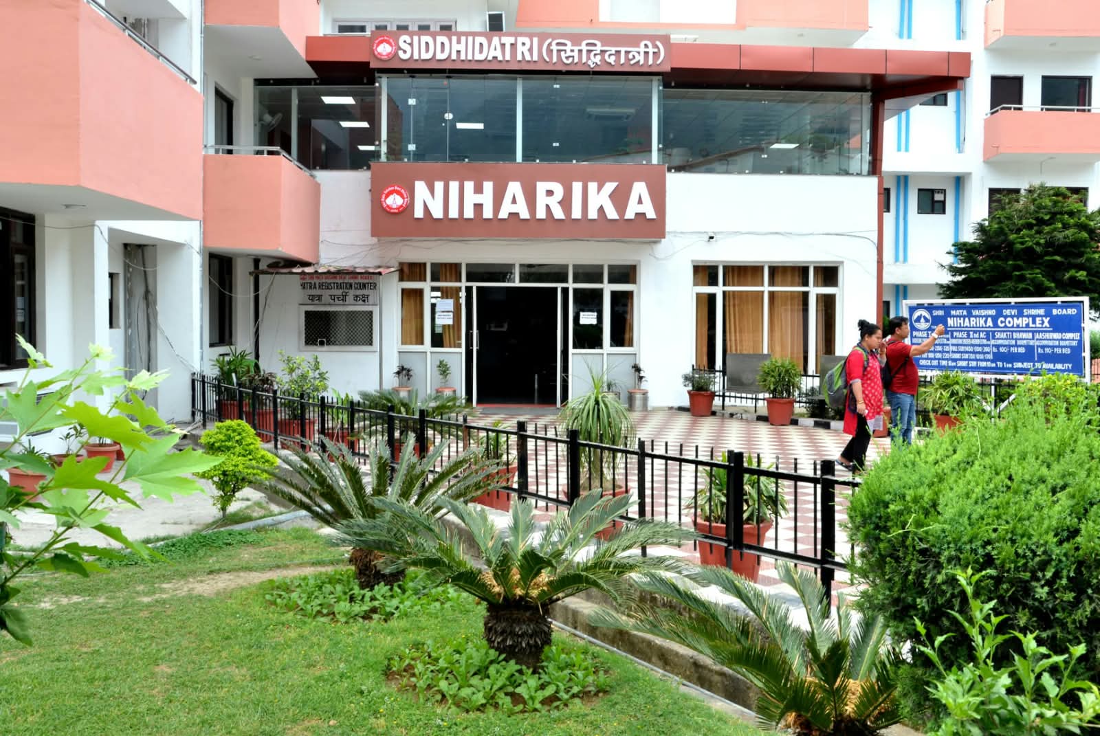 Niharika Complex Katra hotel exterior at golden hour with mountain views